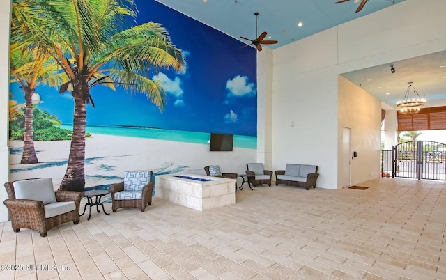 view of patio with ceiling fan and an outdoor fire pit