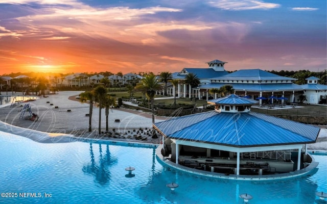 pool at dusk with pool water feature