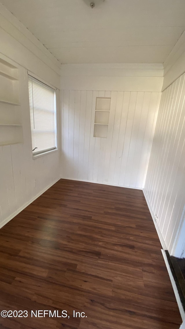 unfurnished room featuring dark wood-type flooring