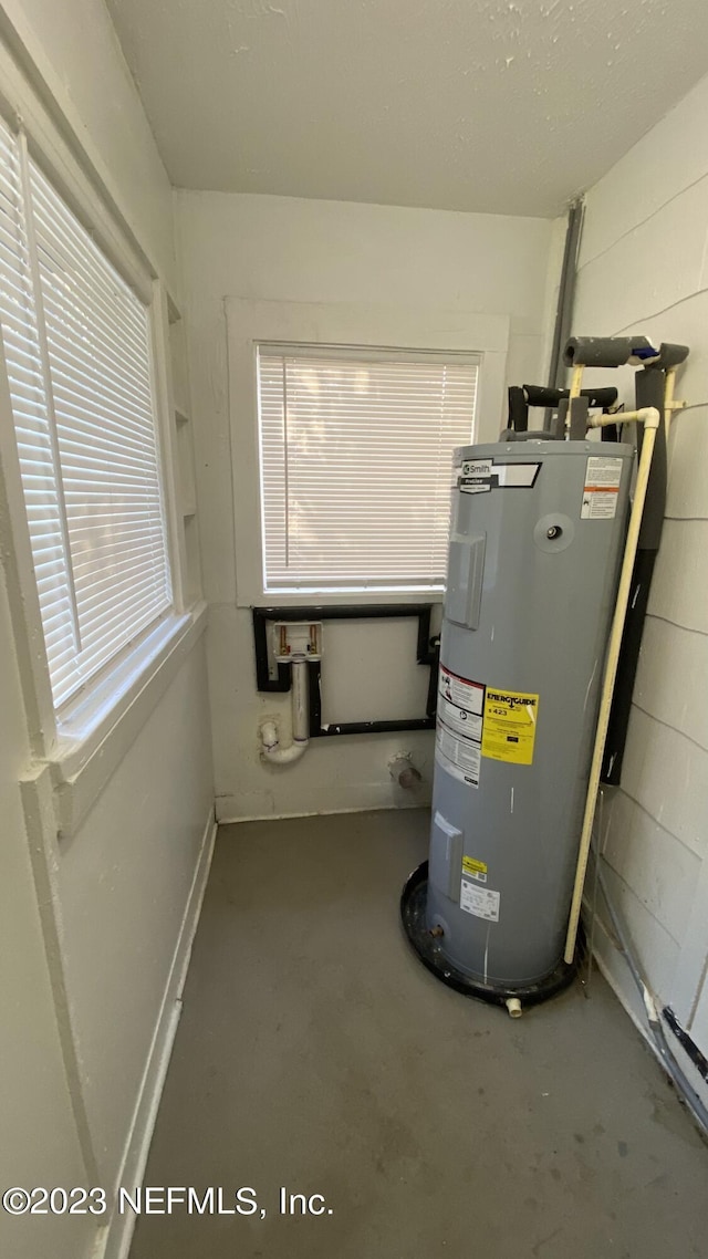 utility room featuring electric water heater