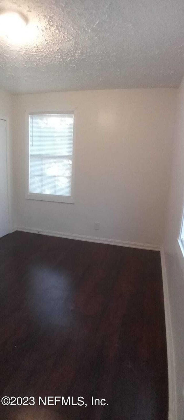 spare room with a textured ceiling