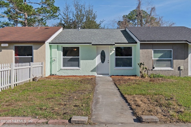 single story home with fence, a front lawn, and stucco siding