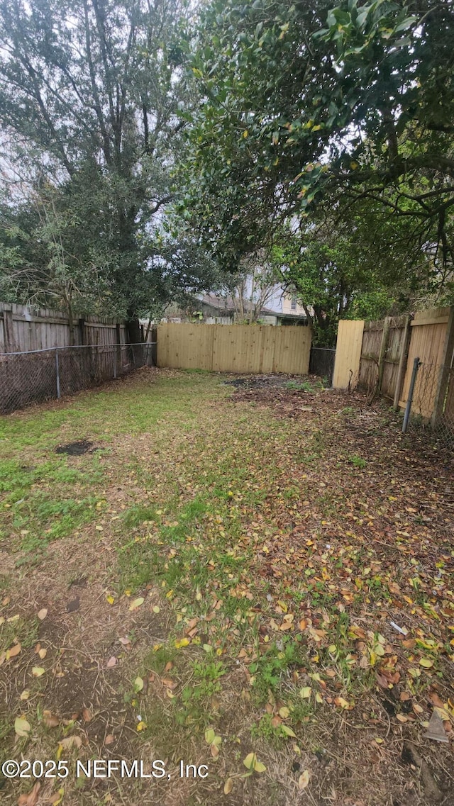 view of yard with a fenced backyard