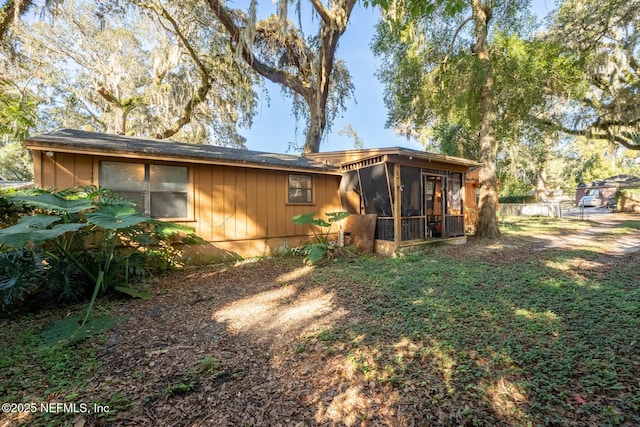 back of property featuring a sunroom