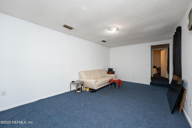 living area with dark carpet and a textured ceiling