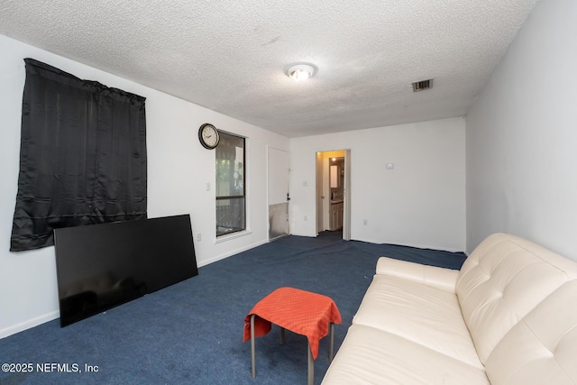 living room with a textured ceiling and carpet floors