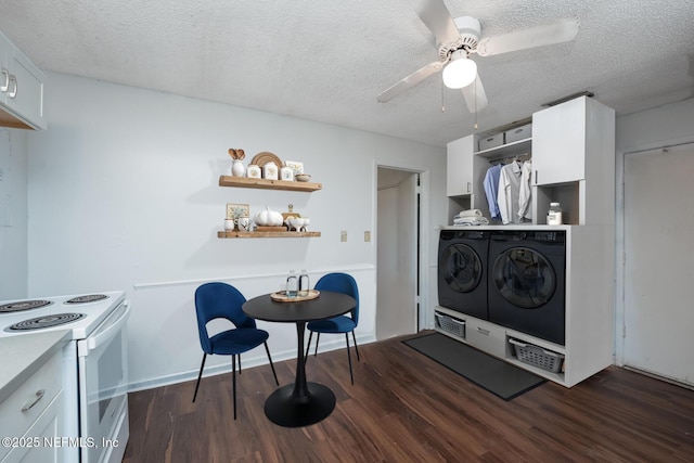 kitchen featuring a textured ceiling, electric range, white cabinetry, and washer and clothes dryer