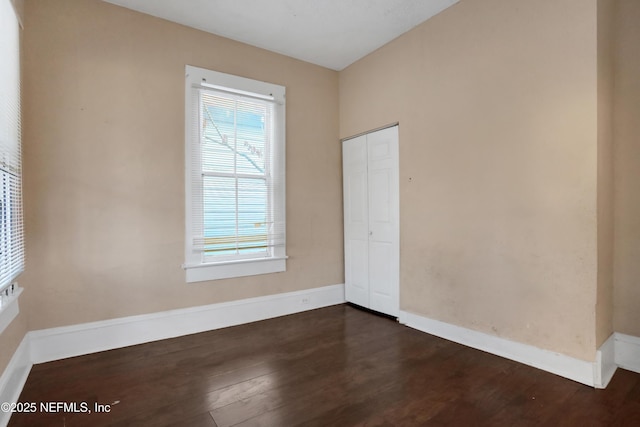 spare room with dark hardwood / wood-style floors