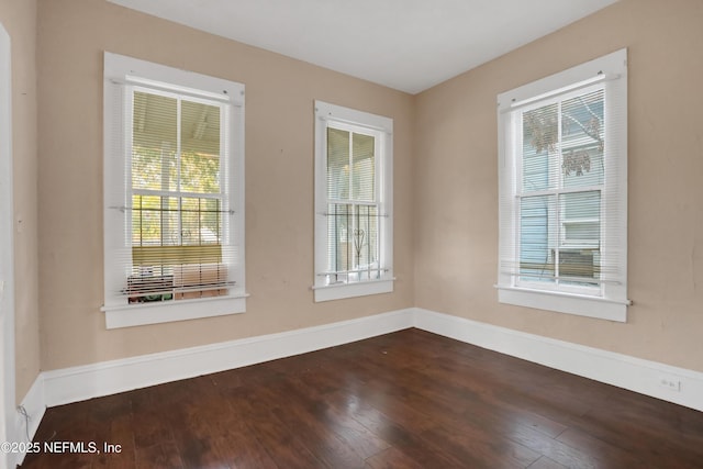 spare room featuring dark wood-type flooring