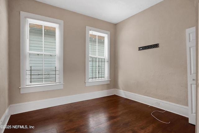 empty room featuring dark hardwood / wood-style flooring