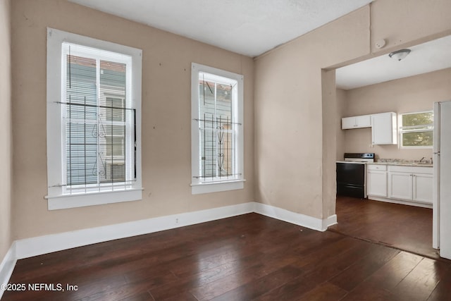 unfurnished dining area with dark hardwood / wood-style flooring