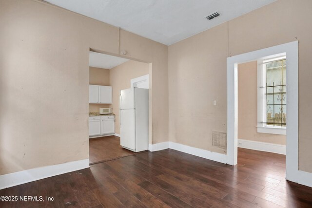 empty room featuring dark hardwood / wood-style flooring