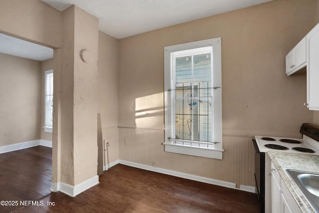 kitchen with white cabinets, white electric range, and dark wood-type flooring