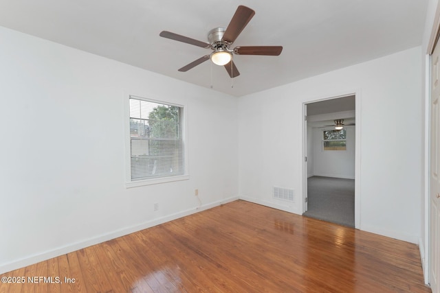 unfurnished room featuring ceiling fan and hardwood / wood-style floors