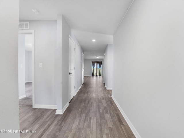 corridor with hardwood / wood-style floors