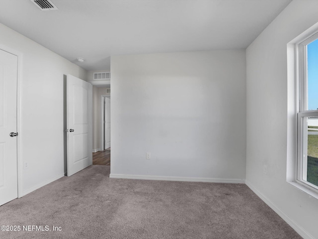 unfurnished room with light carpet