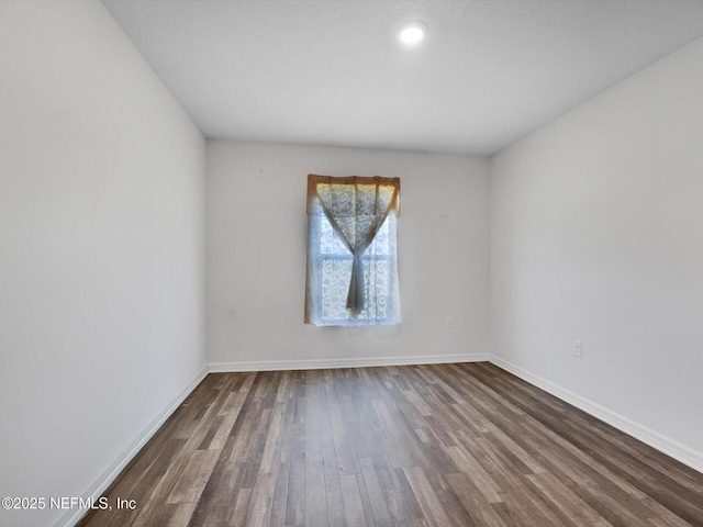 spare room with hardwood / wood-style floors