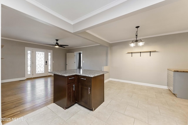 kitchen featuring ceiling fan with notable chandelier, ornamental molding, and pendant lighting