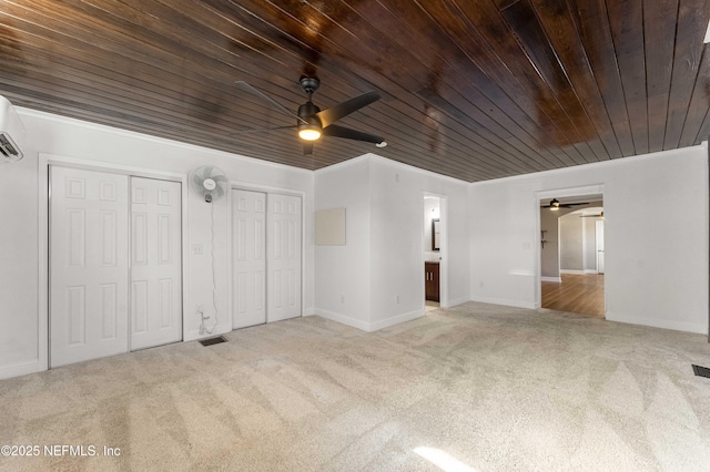 unfurnished bedroom featuring wood ceiling, light colored carpet, ceiling fan, ornamental molding, and two closets