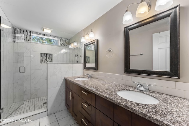 bathroom with vanity, a shower with shower door, and backsplash