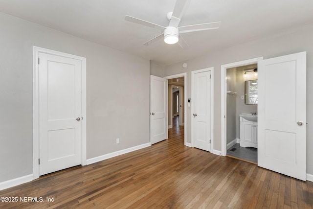 unfurnished bedroom with ceiling fan, hardwood / wood-style floors, and ensuite bath