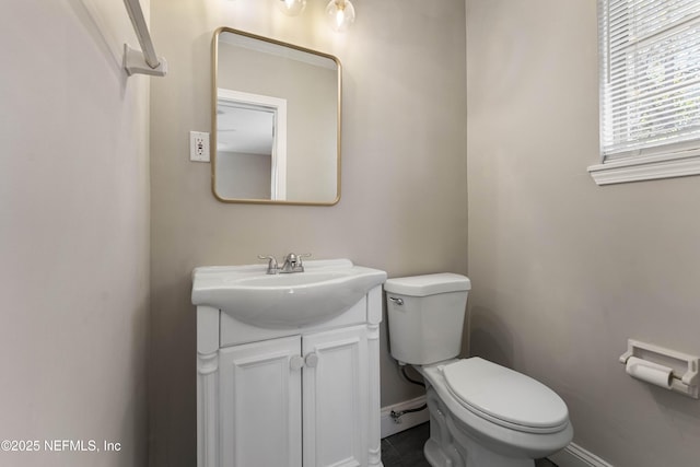 bathroom featuring toilet and vanity