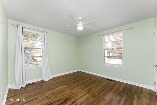 unfurnished room featuring ceiling fan and dark wood-type flooring