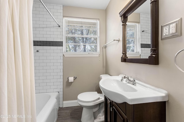 full bathroom featuring toilet, vanity, and shower / bathtub combination with curtain