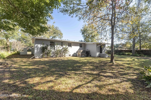 rear view of house with a lawn