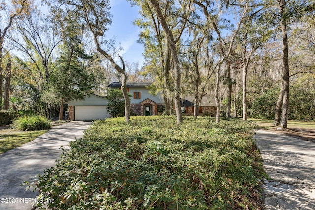 obstructed view of property with a garage