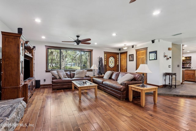 living room featuring ceiling fan and wood-type flooring