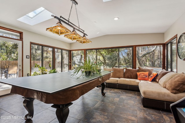 game room with lofted ceiling with skylight