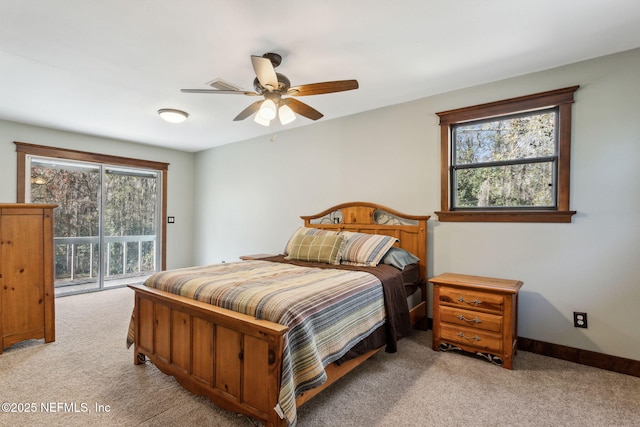 carpeted bedroom featuring ceiling fan, access to exterior, and multiple windows