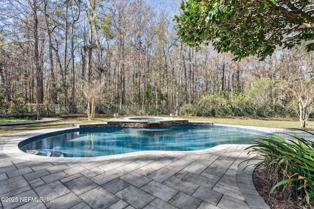 view of pool with an in ground hot tub