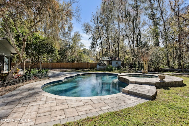 view of swimming pool with a patio area and an in ground hot tub