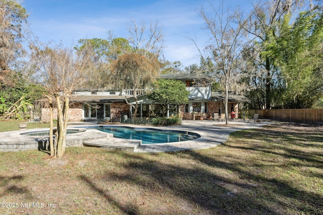 view of pool with an in ground hot tub, a yard, and a patio