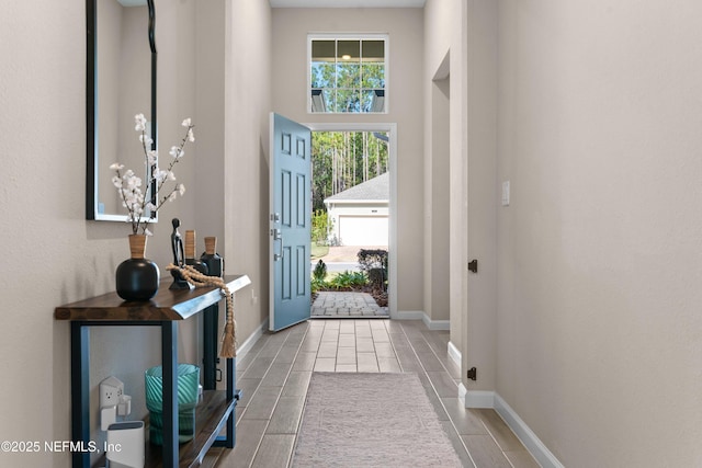 doorway to outside featuring a high ceiling