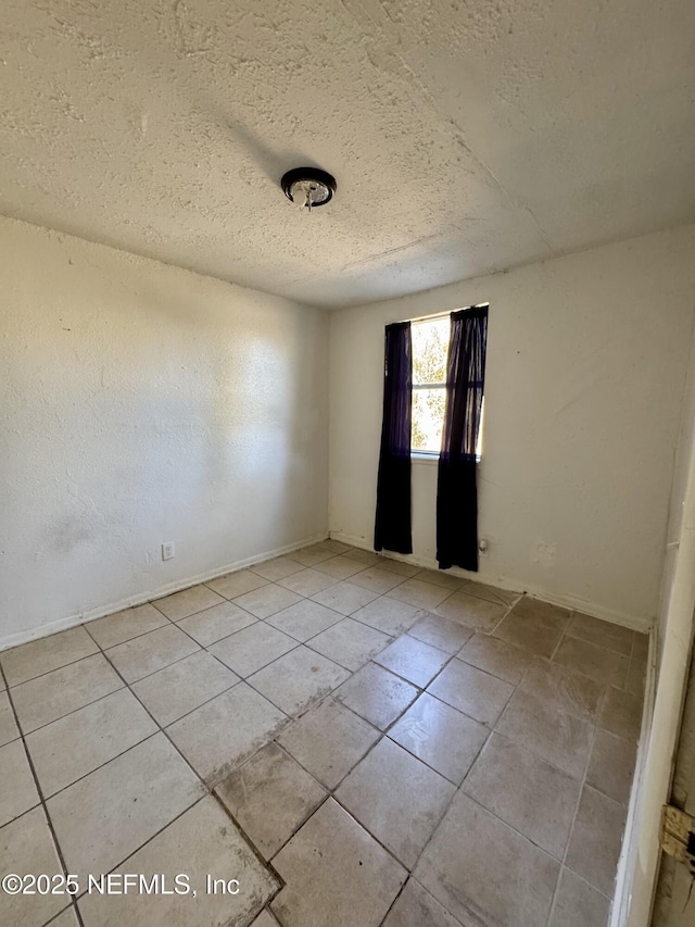 empty room featuring a textured ceiling