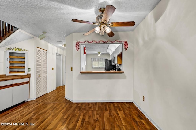 unfurnished living room with ceiling fan, wood-type flooring, and a textured ceiling