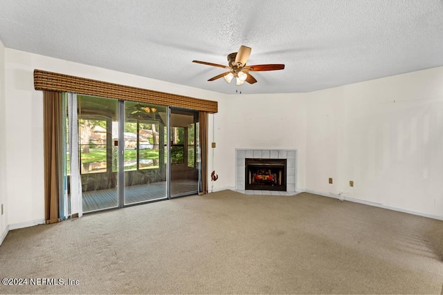 unfurnished living room featuring a fireplace, a textured ceiling, carpet floors, and ceiling fan