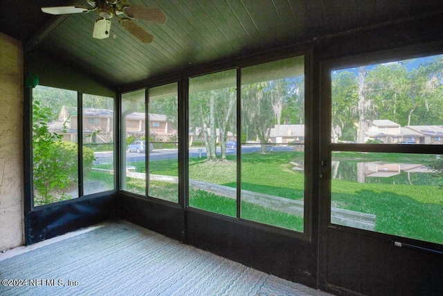 unfurnished sunroom featuring ceiling fan, lofted ceiling, and wooden ceiling