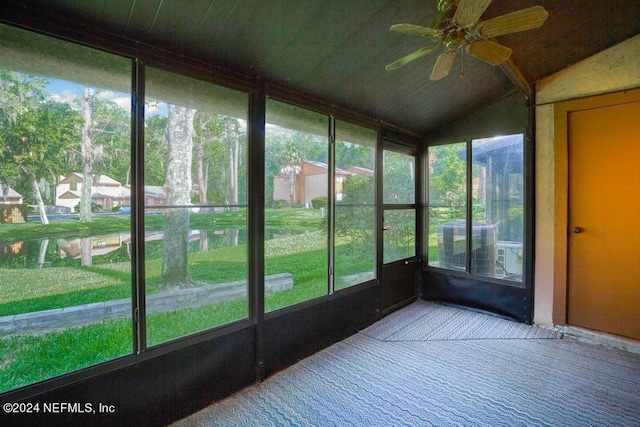 unfurnished sunroom with ceiling fan and lofted ceiling