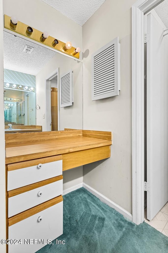 bathroom with vanity and a textured ceiling