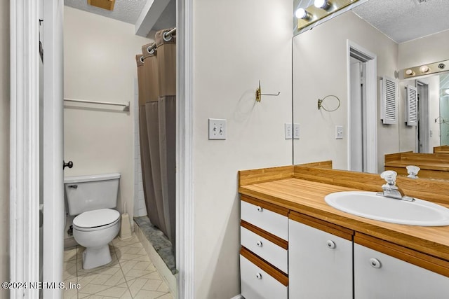 bathroom with curtained shower, vanity, a textured ceiling, and toilet