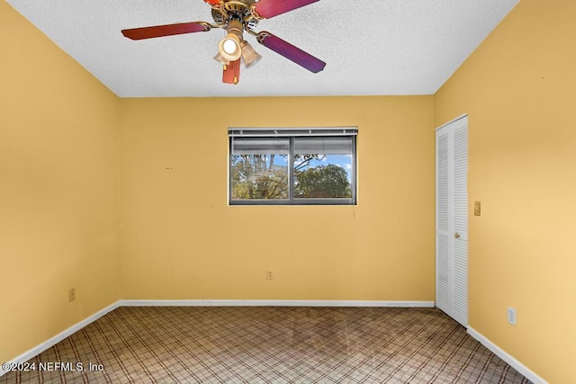 spare room featuring ceiling fan and a textured ceiling