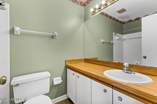 bathroom featuring vanity, toilet, and a shower