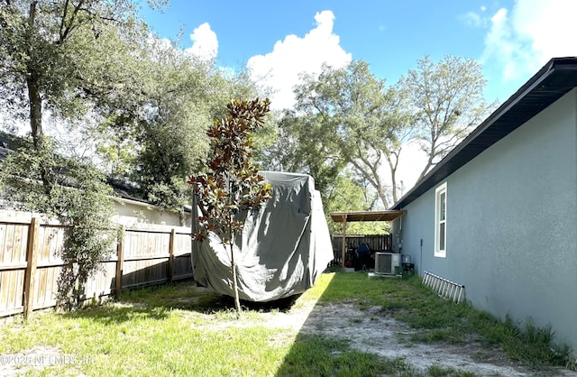 view of yard featuring central air condition unit