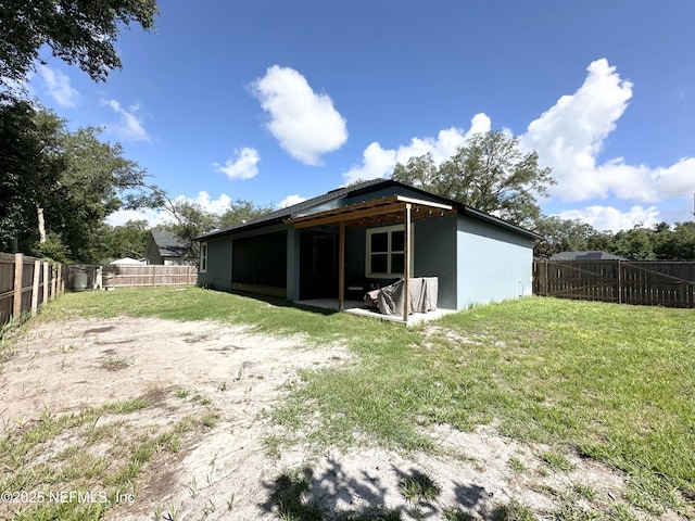 rear view of property with a yard