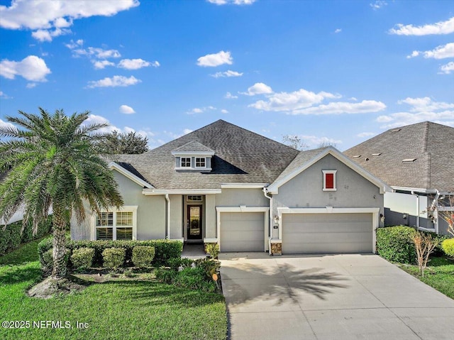 view of front facade featuring a front yard and a garage