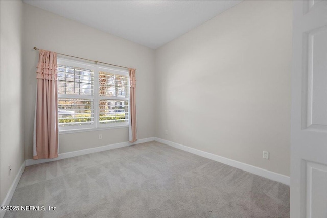 spare room with light colored carpet